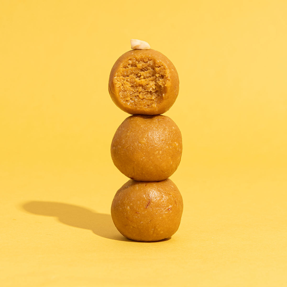 Mishtaa Kesariya Kaju Laddoos, a flavorful sweet made with premium ingredients for guilt-free indulgence.